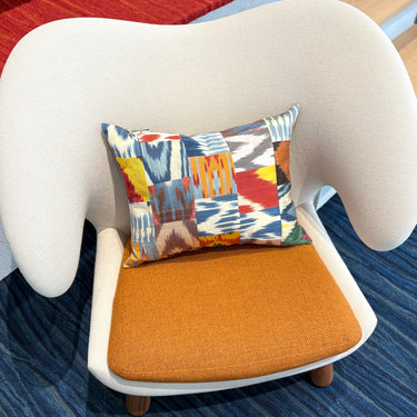 チェアの上に置かれたイカットパッチワーク シルククッション(MC-0705)の写真1